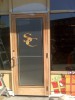 This outside store front door started out as bare metal frame around clear glass.  We wrapped the door to resemble a wooden door for Santa Land.